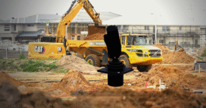 Construction site excavator loading dirt — excavator cab industrial joystick application environment