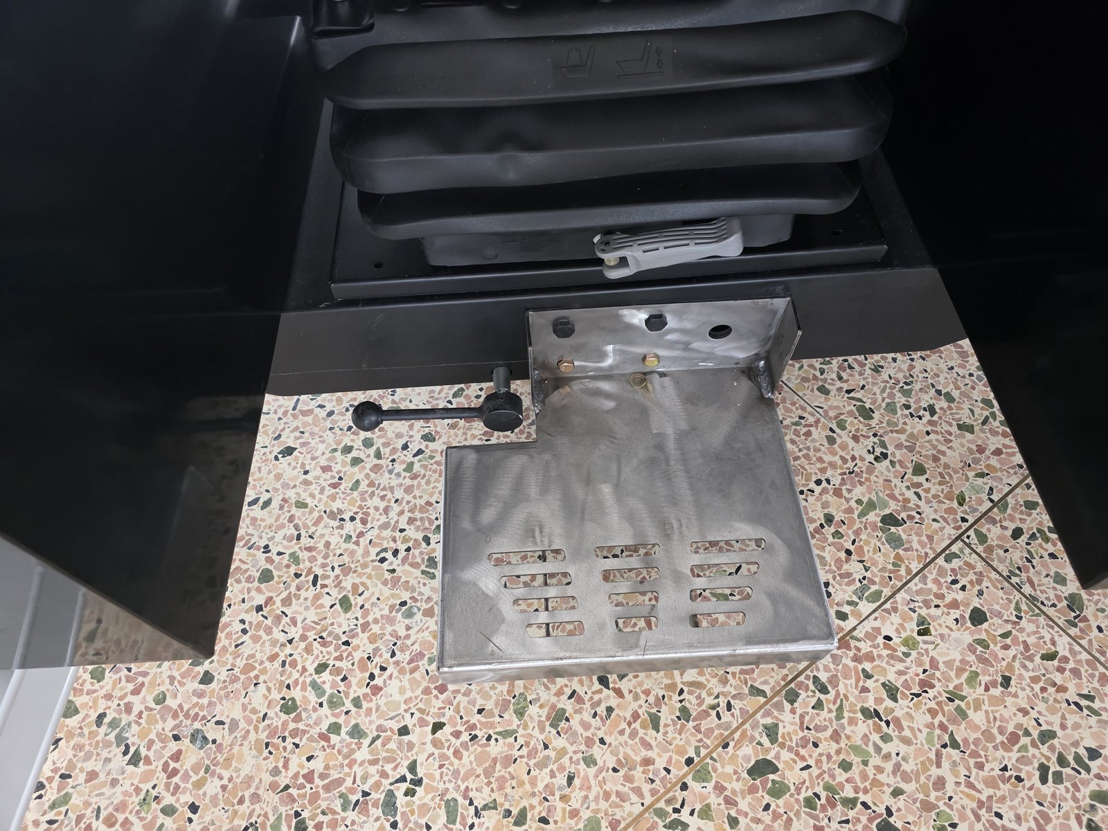 Operator Seat Upgrade: From Punch List to CE-Ready Control Console 1 Custom metal footrest with grip slots on an industrial operator seat — Trunsin control console upgrade